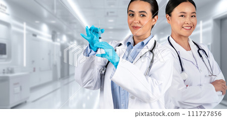 Two medical professionals, one holding a syringe ready for vaccination Two medical professionals, one holding a syringe ready for vaccination 111727856