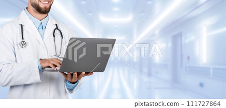 Confident male doctor in white lab coat with a stethoscope around his neck 111727864