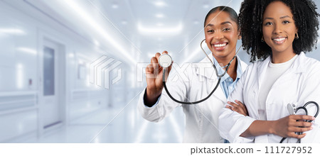Two female healthcare professionals, one with a stethoscope ready for a checkup Two female healthcare professionals, one with a stethoscope ready for a checkup 111727952