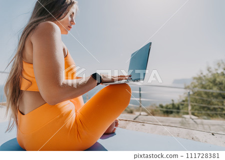 Woman laptop sea. Working remotely on seashore. Happy successful woman female freelancer working on laptop by the sea at sunset, makes a business transaction online. Freelance, remote work on vacation Woman laptop sea. Working remotely on seashore. Happy successful woman female freelancer working on laptop by the sea at sunset, makes a business transaction online. Freelance, remote work on vacation 111728381