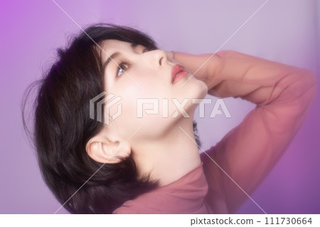 Portrait of a young woman photographed with colorful background 111730664