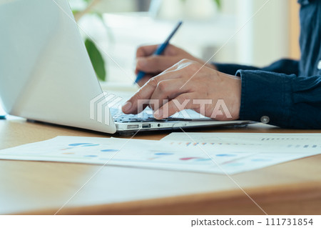 Male hand operating a personal computer Male hand operating a personal computer 111731854