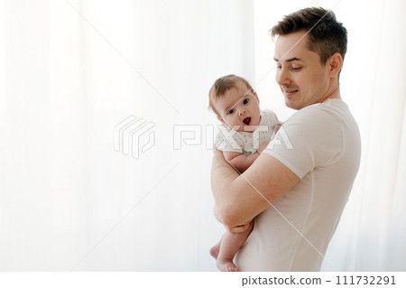 Happy father with baby in arms at home Happy father with baby in arms at home 111732291
