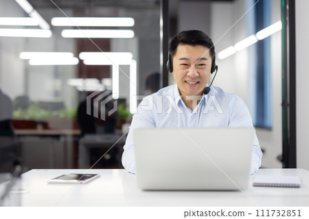 Man with headset phone close-up at workplace inside office, Asian in shirt customer service worker, businessman using laptop for video call, and customer consultation, telephone sales, Man with headset phone close-up at workplace inside office, Asian in shirt customer service worker, businessman using laptop for video call, and customer consultation, telephone sales, 111732851