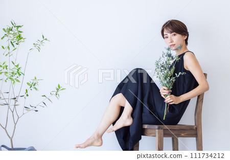Woman sitting on chair Woman sitting on chair 111734212