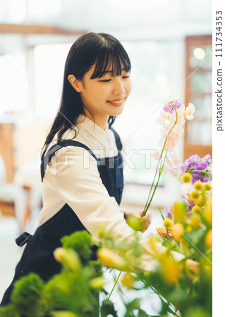 A woman working in a flower shop A woman working in a flower shop 111734353