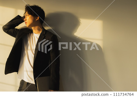 Man by the window in the evening 111734764