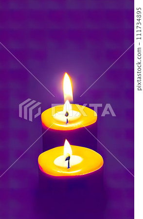 a pair of burning candles. 111734895