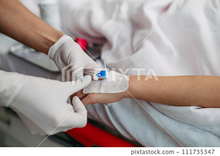 Close up of nurse insering IV cannula in little girl hand. IV, intravenous therapy for child patient. 111735347
