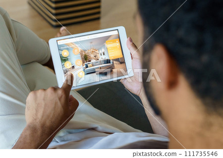 Man adjusting household functions, lighting, security cameras, door locks and thermostat or heating settings in smart home system. Man adjusting household functions, lighting, security cameras, door locks and thermostat or heating settings in smart home system. 111735546