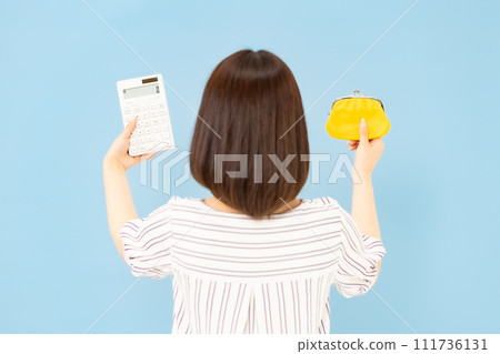 Young woman, 20s, wallet, calculator, back view Young woman, 20s, wallet, calculator, back view 111736131