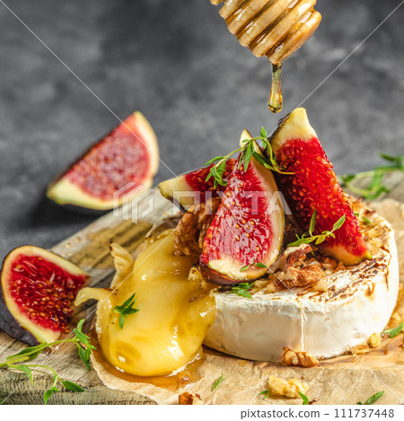 Delicious hot baked camembert with figs, nuts and honey, Restaurant menu, dieting, cookbook recipe top view Delicious hot baked camembert with figs, nuts and honey, Restaurant menu, dieting, cookbook recipe top view 111737448