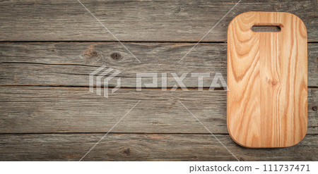Wooden cutting board on a wooden background. top view. copy space 111737471