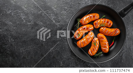 Grilled sausages in a pan on a dark background. top view. copy space for text 111737474