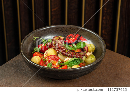 Grilled octopus tentacle with potatoes and tomatoes Grilled octopus tentacle with potatoes and tomatoes 111737613