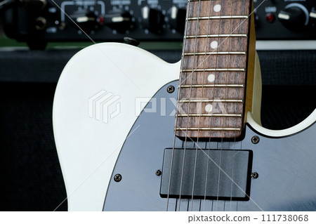 Electric guitar on the background of the guitar amplifier. 111738068