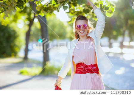 happy elegant 40 years old woman in dress and jacket in city 111738310