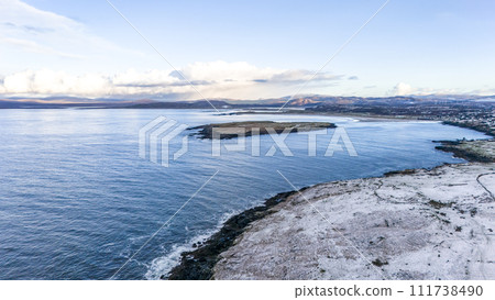Aerial view of snow covered Inishkeel island by Portnoo in County Donegal, Ireland. 111738490