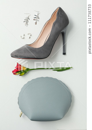 Female shoes, accessories and flower on white background, top view Female shoes, accessories and flower on white background, top view 111738733