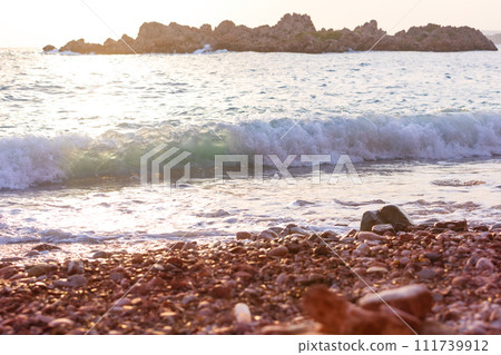 Pebbles on beach and sea water close-up Pebbles on beach and sea water close-up 111739912
