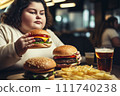 Fat girl eating hamburger in fast food restaurant.  111740238
