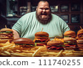 Fat man eating hamburger in fast food restaurant.  111740255