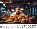 Fat man eating hamburger in fast food restaurant.  111740257