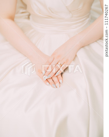 Hands of a pregnant woman wearing a dress Hands of a pregnant woman wearing a dress 111740267