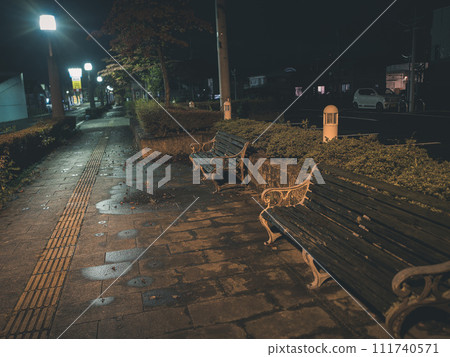 Night scene with bench wet from rain 111740571