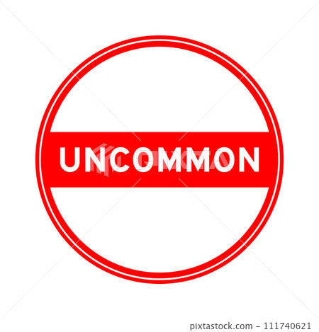 Red color round seal sticker in word uncommon on white background 111740621