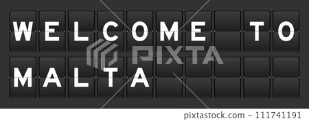 Black color analog flip board with word welcome to malta on gray background 111741191
