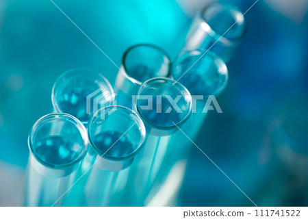 Chemical test tubes close-up with blue liquid. Medicine, pharmaceuticals, chemistry Chemical test tubes close-up with blue liquid. Medicine, pharmaceuticals, chemistry 111741522