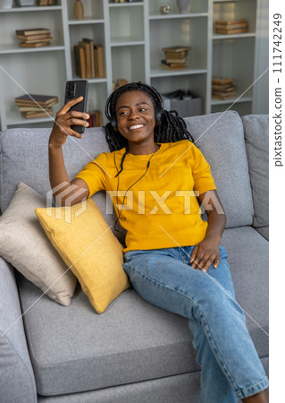Smiling cute young woman spending time at home and looking happy 111742249