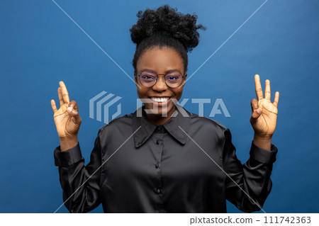 Happy african american woman smiling nicely Happy african american woman smiling nicely 111742363