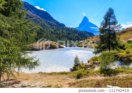 View of Moosjisee lake and Matterhorn mountain at summer on the Five Lakes Trail in Zermatt, Switzerland View of Moosjisee lake and Matterhorn mountain at summer on the Five Lakes Trail in Zermatt, Switzerland 111742419