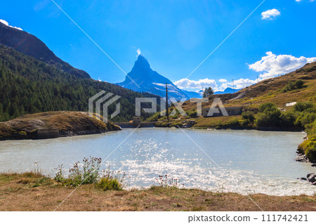 View of Moosjisee lake and Matterhorn mountain at summer on the Five Lakes Trail in Zermatt, Switzerland View of Moosjisee lake and Matterhorn mountain at summer on the Five Lakes Trail in Zermatt, Switzerland 111742421