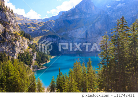 View of Oeschinen lake (Oeschinensee) and Swiss Alps near Kandersteg in Bernese Oberland, Switzerland View of Oeschinen lake (Oeschinensee) and Swiss Alps near Kandersteg in Bernese Oberland, Switzerland 111742431