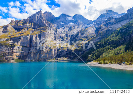 View of Oeschinen lake (Oeschinensee) and Swiss Alps near Kandersteg in Bernese Oberland, Switzerland View of Oeschinen lake (Oeschinensee) and Swiss Alps near Kandersteg in Bernese Oberland, Switzerland 111742433