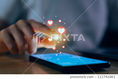 Hand using smartphone and chatting on social media with show heart icon. 111742861