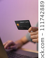 Close-up of hand holding credit card and type on laptop keyboard with online payment for shopping. 111742889