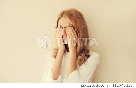 Tired overworked woman employee rubbing her eyes suffering from eye strain or headaches 111743135