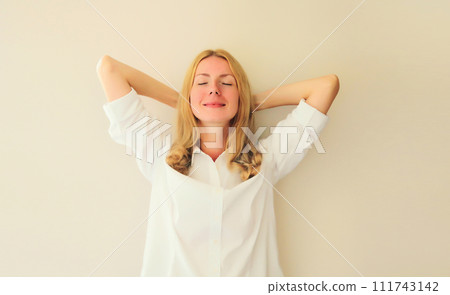 Relaxed happy young woman take a break meditates with closed eyes while working Relaxed happy young woman take a break meditates with closed eyes while working 111743142
