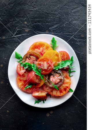Fresh tomato and rocket salad. A variety of tomatoes of different sorts 111743434