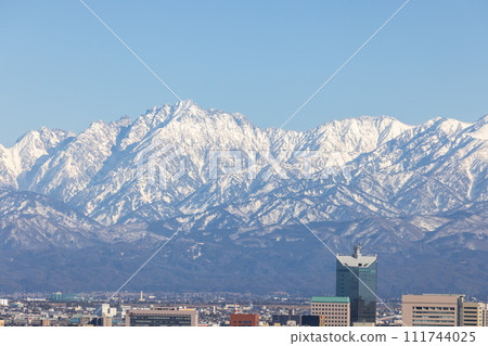 Shinkansen running with the Tateyama mountain range in the background Shinkansen running with the Tateyama mountain range in the background 111744025