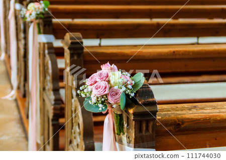 Close-up of a beautiful flower wedding decoration in church Close-up of a beautiful flower wedding decoration in church 111744030