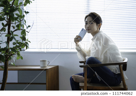 Middle woman using a smartphone Middle woman using a smartphone 111744062