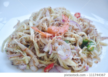 chop unripe mango with dry shrimp and chili Thai salad on plate chop unripe mango with dry shrimp and chili Thai salad on plate 111744367