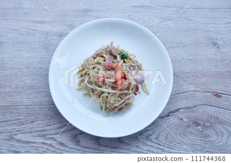 chop unripe mango with dry shrimp and chili Thai salad on plate chop unripe mango with dry shrimp and chili Thai salad on plate 111744368