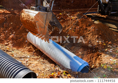 Installation of pipes at construction site that allow rainwater to flow into water main collector 111744458
