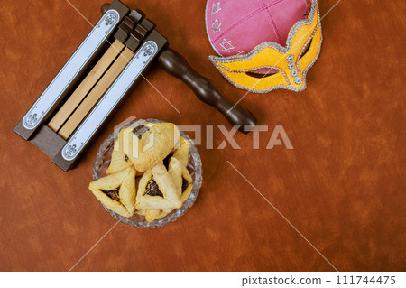 Carnival mask, hamantaschen cookies, noisemakers, were used to celebrate Jewish holiday of Purim 111744475